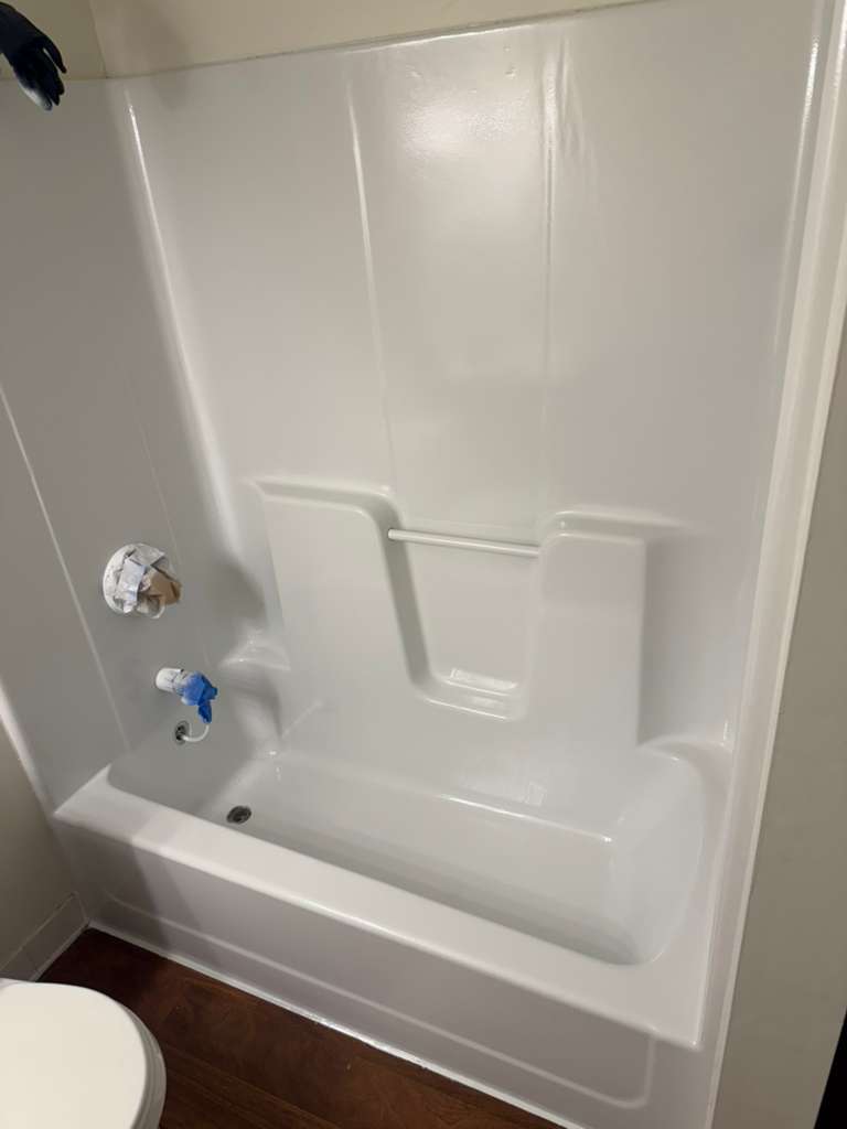 Glossy reglazed tub-surround unit with fixtures masked