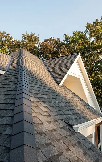 Precision charcoal roofing and a pristine home exterior in natural daylight