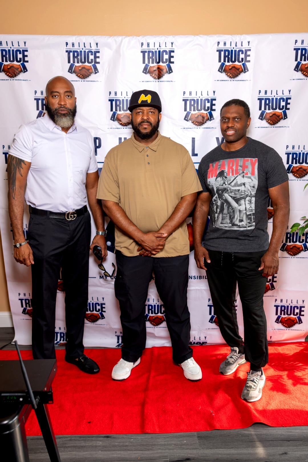 Three facilitators standing on the red carpet