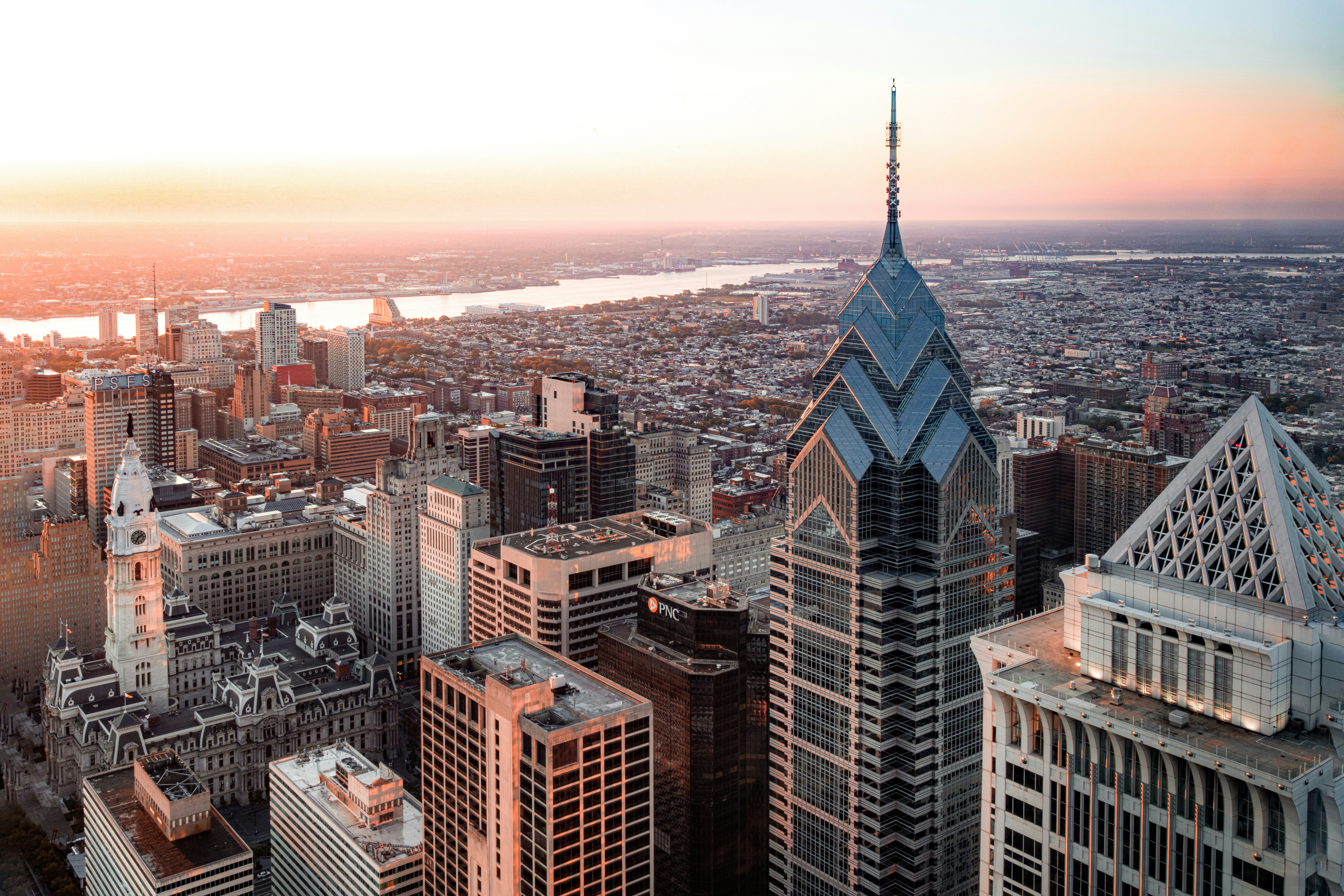 Philadelphia at sunrise — Center City towers above the rowhomes and the river