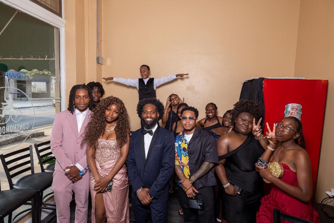 Cohort members and facilitators posing together in the lobby