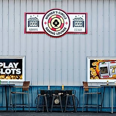 Exterior signage and patio seating at Winner's Circle Gaming Lounge in Albany, Illinois