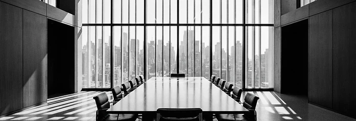 Empty modernist boardroom with dramatic geometric shadows