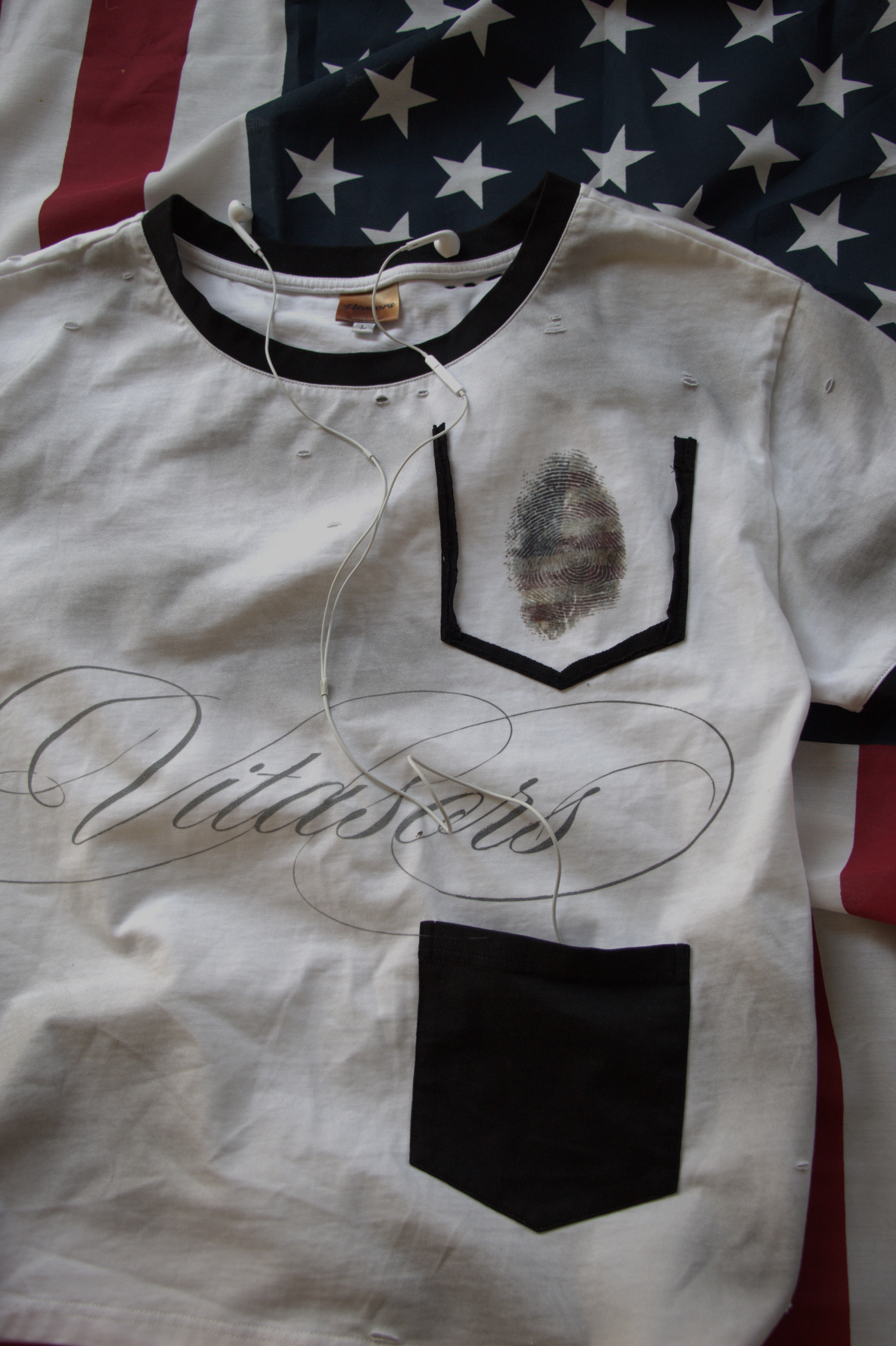 Vitasors tee detail on folded American flag