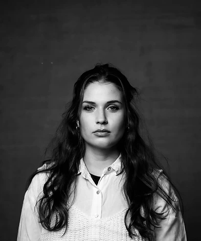 Schwarz-weiss Porträt von Celia Pierina vor dunkler Studio-Wand
