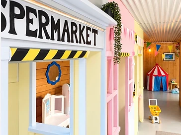 Colourful indoor pretend-play supermarket with pastel play shops at Blue Cedar garden centre, Ballynahinch