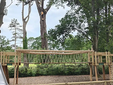 Wooden rope suspension bridge in the woodland playground beside The Potting Shed, Glenarm