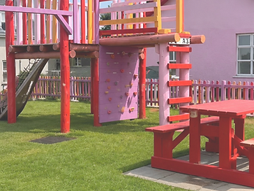 Colourful children's playground with a climbing wall and slide beside Dora's coffee shop, Portrush