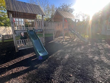 Two wooden play towers with dark green slides at Langtry Lane, Moira