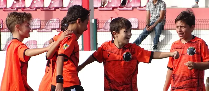 Quatro jovens atletas do Panther Force a festejar no relvado