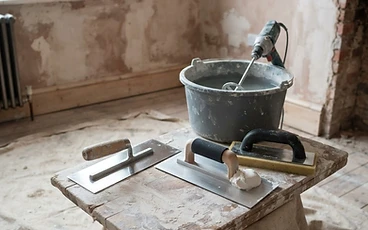 Plastering tools laid out in a room being renovated