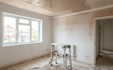 Interior ceiling being plastered in an empty room