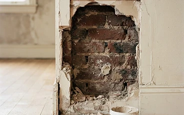 Damaged plaster cut back ready for repair