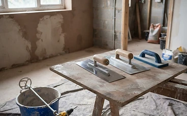 Plastering tools laid out in a room being renovated