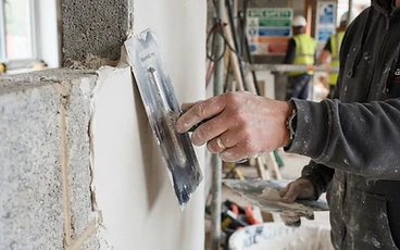 Plaster repair work on a cracked wall with trowel application