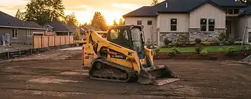 Professional yard grading with heavy equipment preparing a residential lawn for new sod in the South Carolina Lowcountry