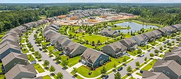 Aerial view of a growing Cane Bay neighborhood with new homes and fresh lawns in the South Carolina Lowcountry