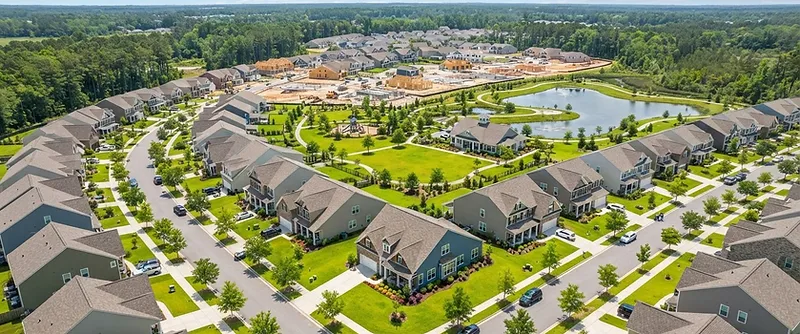 Aerial view of a growing Cane Bay neighborhood with new homes and fresh lawns in the South Carolina Lowcountry