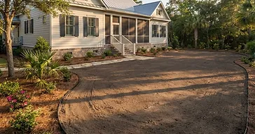 Finished graded southern Lowcountry residential yard with smooth level bare soil surface sloping away from a home, ready for new sod or landscape installation