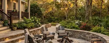 Professional hardscape installation with paver patio, fire pit, and retaining wall in a South Carolina Lowcountry backyard