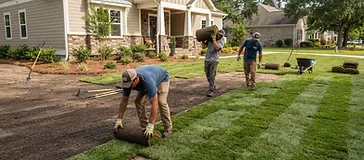 Fresh sod being rolled out and installed on a prepared lawn in the Cane Bay community in the South Carolina Lowcountry