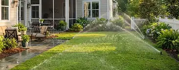 Summers Corner backyard with a newly installed underground irrigation sprinkler system watering a fresh green lawn in South Carolina
