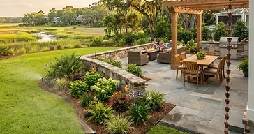 Integrated southern backyard hardscape with paver patio, retaining wall, landscape beds and drainage in the Lowcountry