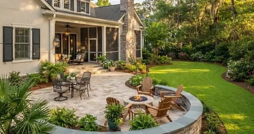 Southern Lowcountry backyard with a newly installed hardscape design featuring paver patio, landscape beds and retaining wall