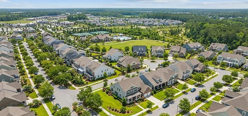 New Nexton home with fresh sod being watered by irrigation sprinklers during establishment in the South Carolina Lowcountry