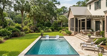 Southern Lowcountry backyard with a swimming pool, lush lawn and manicured landscape beds after a landscape update