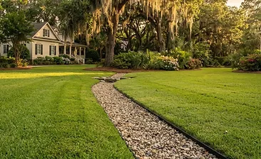 A clean newly installed French drain system alongside a garden bed in Nexton, SC
