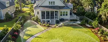Mt. Pleasant backyard with a newly installed underground irrigation sprinkler system watering a fresh green lawn in South Carolina
