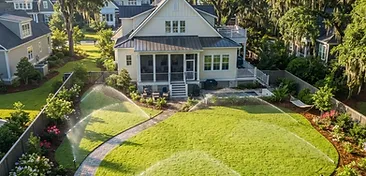Mt. Pleasant backyard with a newly installed underground irrigation sprinkler system watering a fresh green lawn in South Carolina