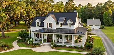Classic southern farmhouse on expansive green land in the Moncks Corner area of the South Carolina Lowcountry with mature oak trees and a large wraparound porch