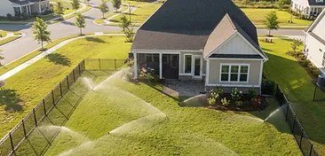 Nexton backyard with a newly installed underground irrigation sprinkler system watering a fresh green lawn in South Carolina