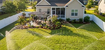 Cane Bay backyard with a newly installed underground irrigation sprinkler system watering a fresh green lawn in South Carolina