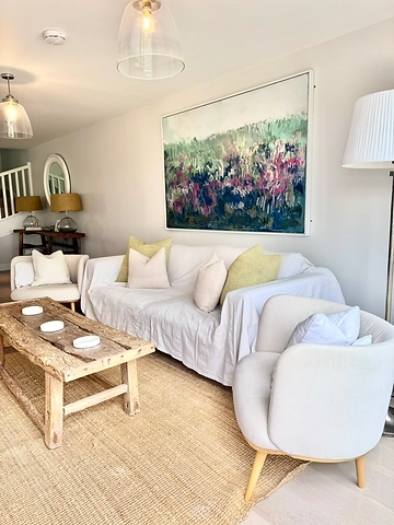 Living room detail with sofa, throw pillows and console lamps