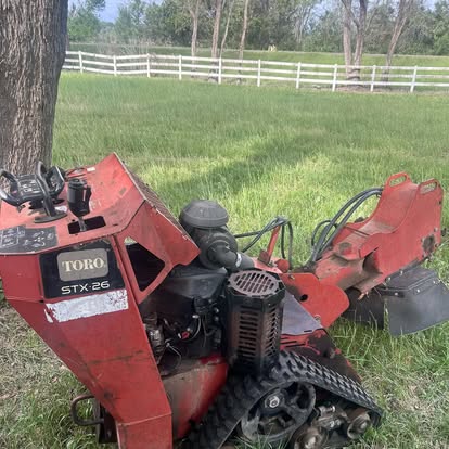 Toro STX-26 stump grinder on a grassy lawn
