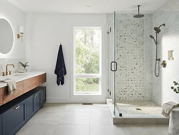 Full bathroom remodel with custom shower, warm wood vanity and natural light