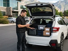 Courier organizing multiple deliveries for a scheduled route in Utah