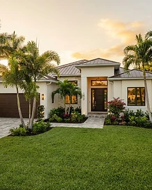Renovated South Florida home exterior at golden hour with new impact windows