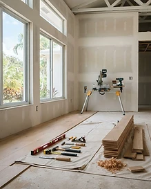 Tidy home renovation work area with tools and new flooring being installed