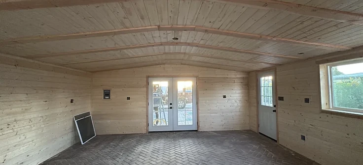 Knotty pine paneled room with French doors