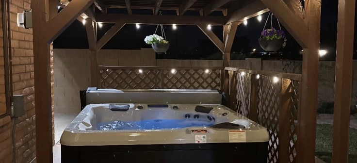Custom pergola over hot tub with string lights