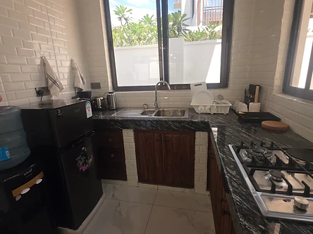 Kitchen — corner layout with hob, sink and water dispenser