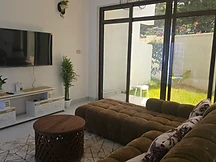 Living room — brown sectional sofa and gold-accent media console