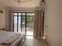 Double bedroom — bright room with air-conditioning unit