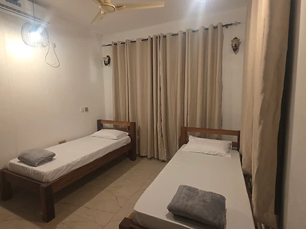 Twin bedroom — two single beds with air-conditioning