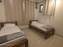 Twin bedroom — two single beds by curtained window