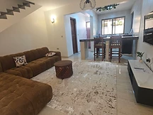 Living room — lounge flowing into the open kitchen and breakfast bar